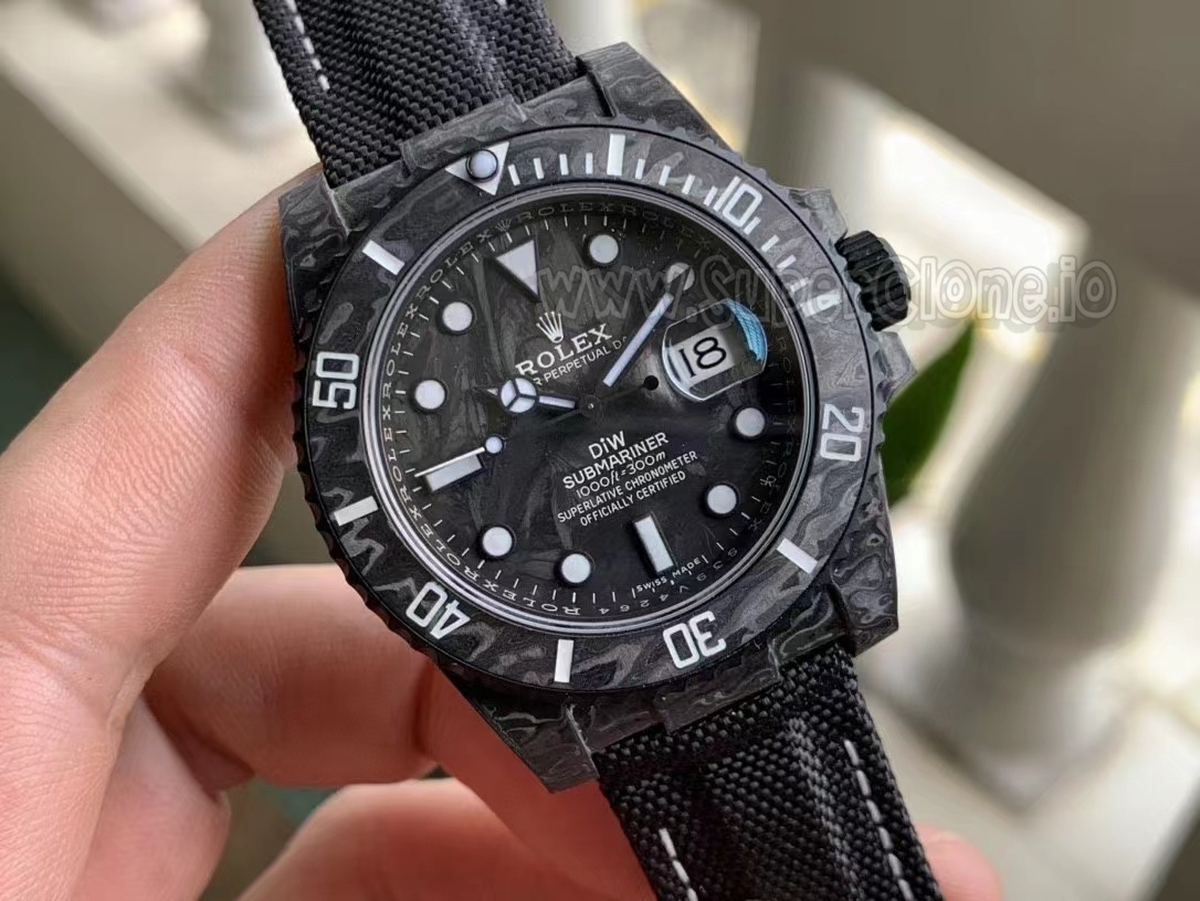 Close-up view of the black carbon fiber dial texture with distinct DiW printing