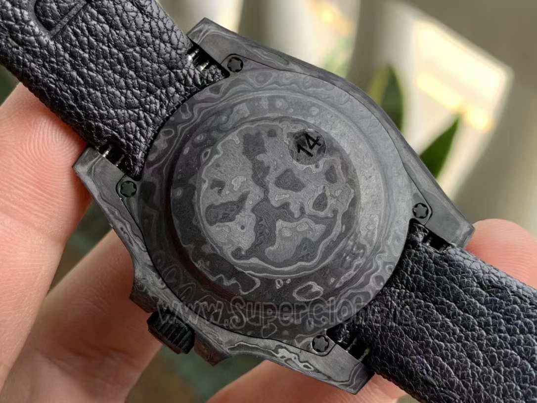 Screwed-down forged carbon case back showing text engravings