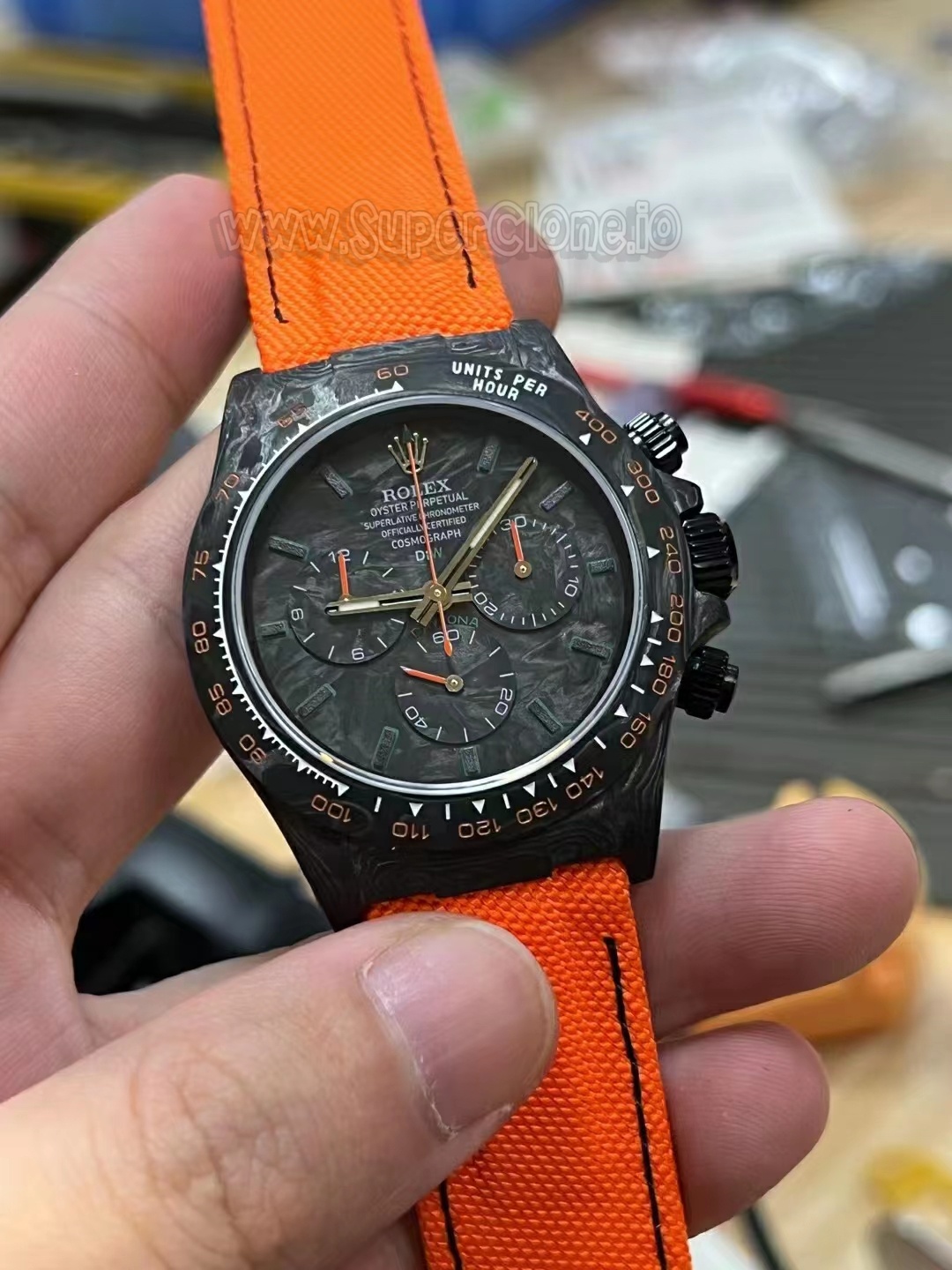 Macro detail of the chronograph sub-dials over carbon backing